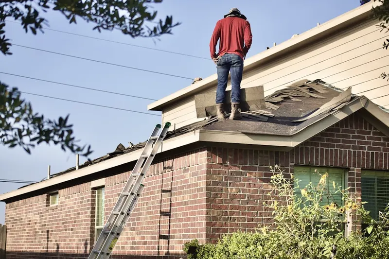 Professional roofer working on a residential roof in Shipyard Plantation